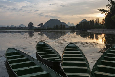 Wooden boats at sunrise in puzhehei - yunnan, china