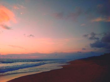 Scenic view of beach against sky during sunset