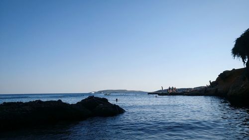 Scenic view of sea against clear blue sky