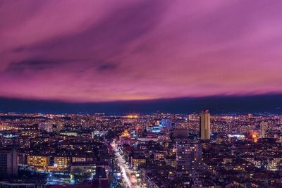 High angle view of city lit up at night