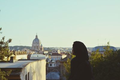 Rear view of woman with church in background