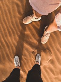 Low section of people standing at desert