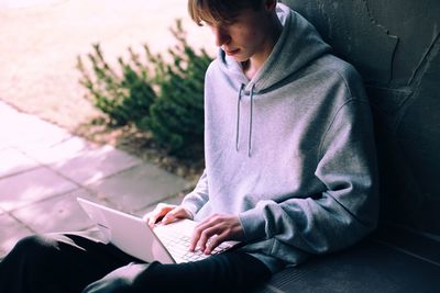 High angle view of man sitting on book