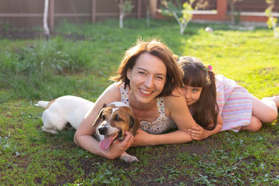 Portrait of woman with dog on grass