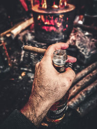 Close-up of hand holding cigarette