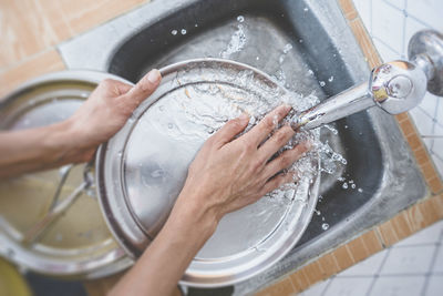 High angle view of hand holding water at home
