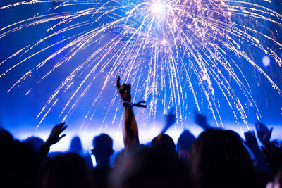 Low angle view of firework display at night