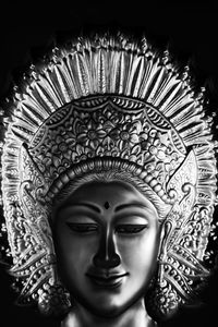 Close-up of buddha statue against building