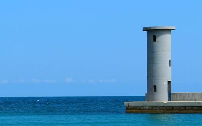 View of lighthouse against clear blue sky