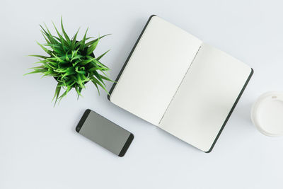 High angle view of laptop on table against white background