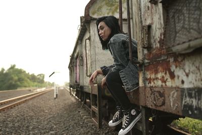 Side view of woman looking away in city