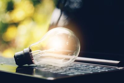 Close-up of light bulb on table