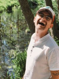 Portrait of young man standing in forest