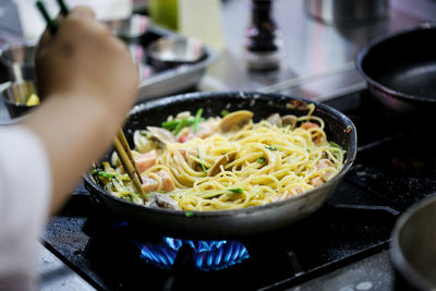 Midsection of person preparing food in kitchen