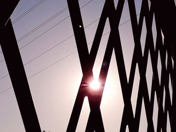 Low angle view of silhouette bridge against sky during sunset