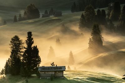 High angle view of house on landscape during foggy weather