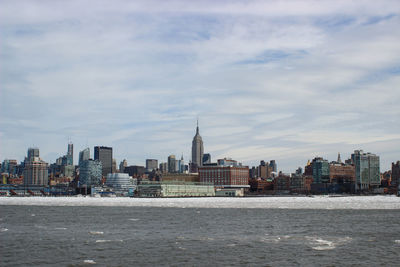 Sea with buildings in background