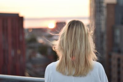 Rear view of a woman looking out at the city