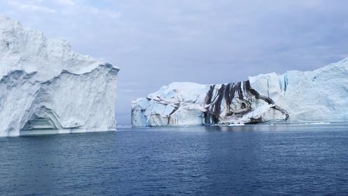 Scenic view of icebergs against sky