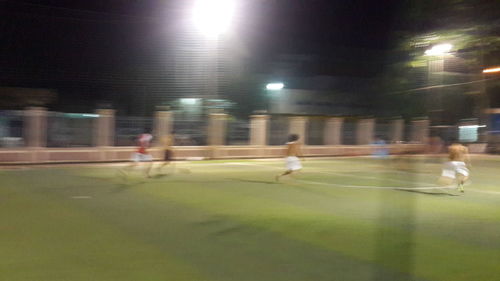 Blurred motion of woman at night