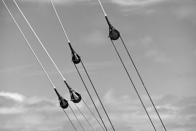 Low angle view of pulleys against sky