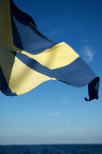 Close-up of flag against clear blue sky