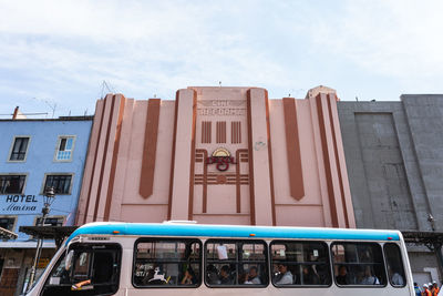 Graffiti on building against sky in city