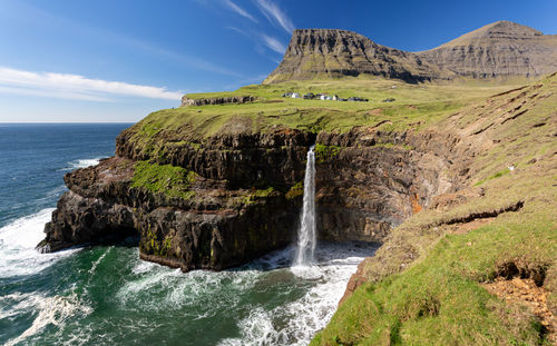 Scenic view of waterfall against sky