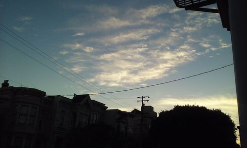 Low angle view of silhouette buildings against sky during sunset