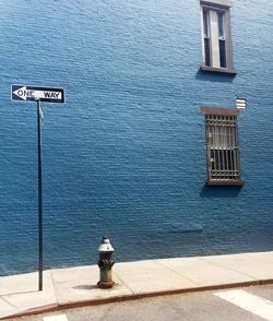 Information sign against blue building