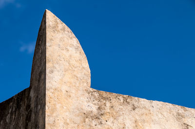 Low angle view of historical building against blue sky