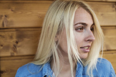 Close-up of young woman against wall