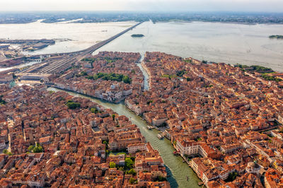 Amazing city view from above on building roofs and canals. aerial view of venice, san polo, italy