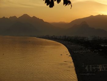 Scenic view of beach against sky during sunset