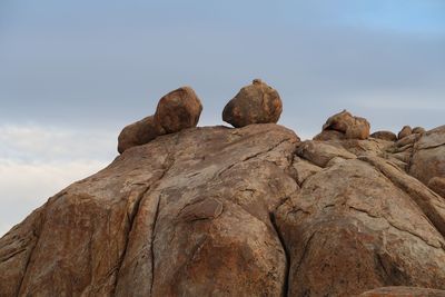 Low angle view of rock formation against sky