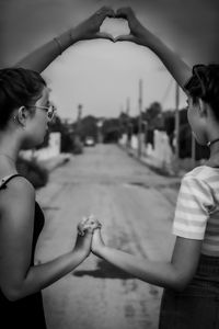 Mother and daughter standing on hands