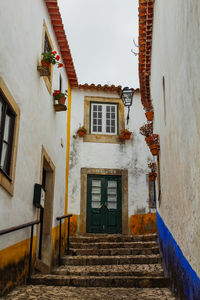 Low angle view of residential buildings against sky in medieval town of obidos