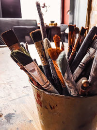 Close-up of paintbrushes in container on table