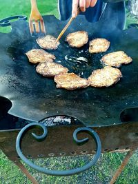 High angle view of person preparing food on barbecue grill