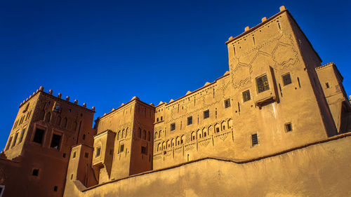 Low angle view of temple against clear blue sky