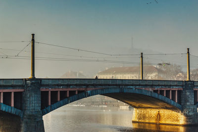 Autumn morning in prague under the empty bridge with warm sunlight