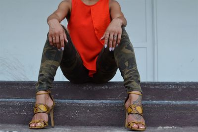 Low section of woman sitting on steps