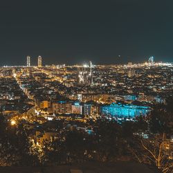 Illuminated cityscape against clear sky at night