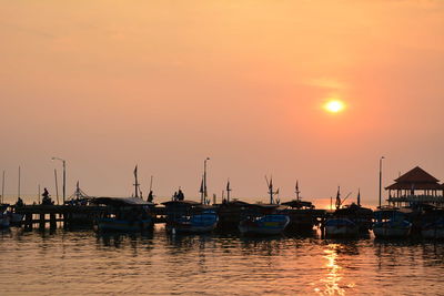 Sailboats in marina at sunset