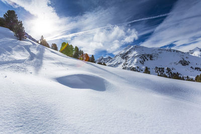 Scenic view of snow covered mountains against sky