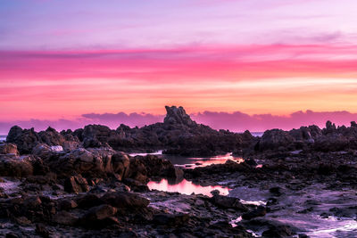 Scenic view of rock formation against sky during sunset