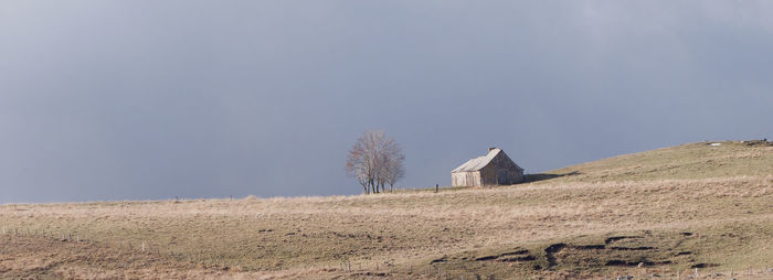 Panoramic view of house on field against sky