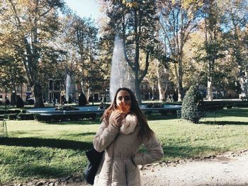 Portrait of woman standing in park