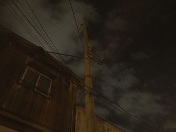 Low angle view of electricity pylon against sky