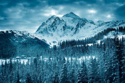 Close-up of snow covered mountain against sky